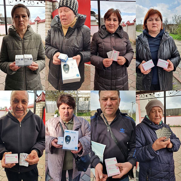 Adults in Ukraine holding insulin donated by IDDT members